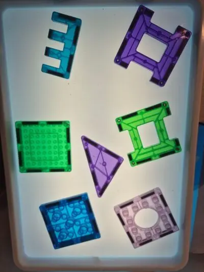 Our light box in preschool is a wonderful hands-on learning resource that encourages children to explore, investigate, and learn through play. The colourful translucent shapes allow children to experiment with colour, light, shapes, patterns, and construction in a fun and engaging way. As children arrange and combine the pieces, they develop their fine-motor skills, creativity, problem-solving, spatial awareness, and early mathematical thinking. The light box also provides opportunities for children to work together, share ideas, and talk about what they notice, making learning both meaningful and enjoyable! 🤍 magnets preschool nursery